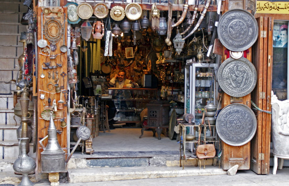 A vendor sits inside an antique shop in al-Jdeideh neighborhood, in the Old City of Aleppo, in 2009.