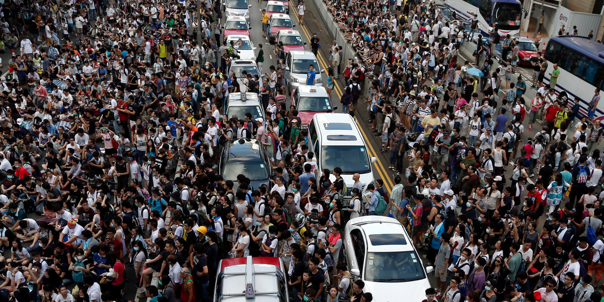 Traffic stands still as tens of thousands of protesters jam the main street leading to the financial Central district outside the government headquarters in Hong Kong.