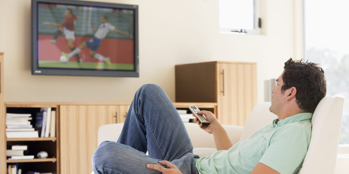 Man in living room watching television