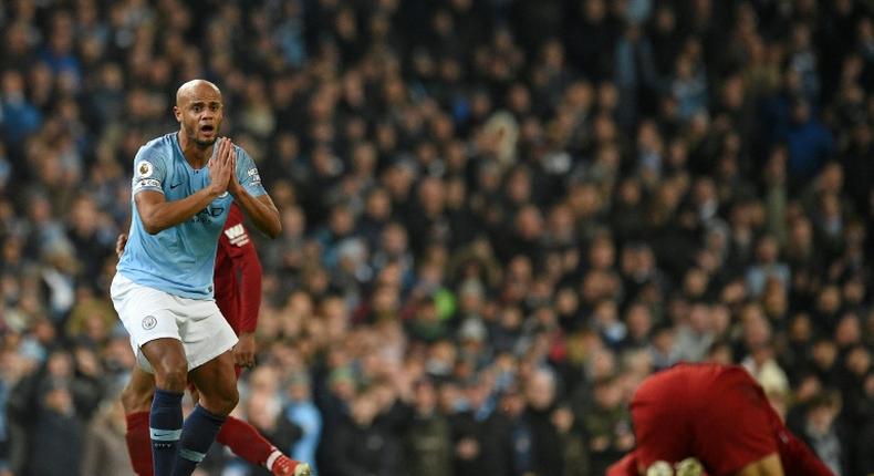 Manchester City's Vincent Kompany reacts after fouling Liverpool's Mohamed Salah