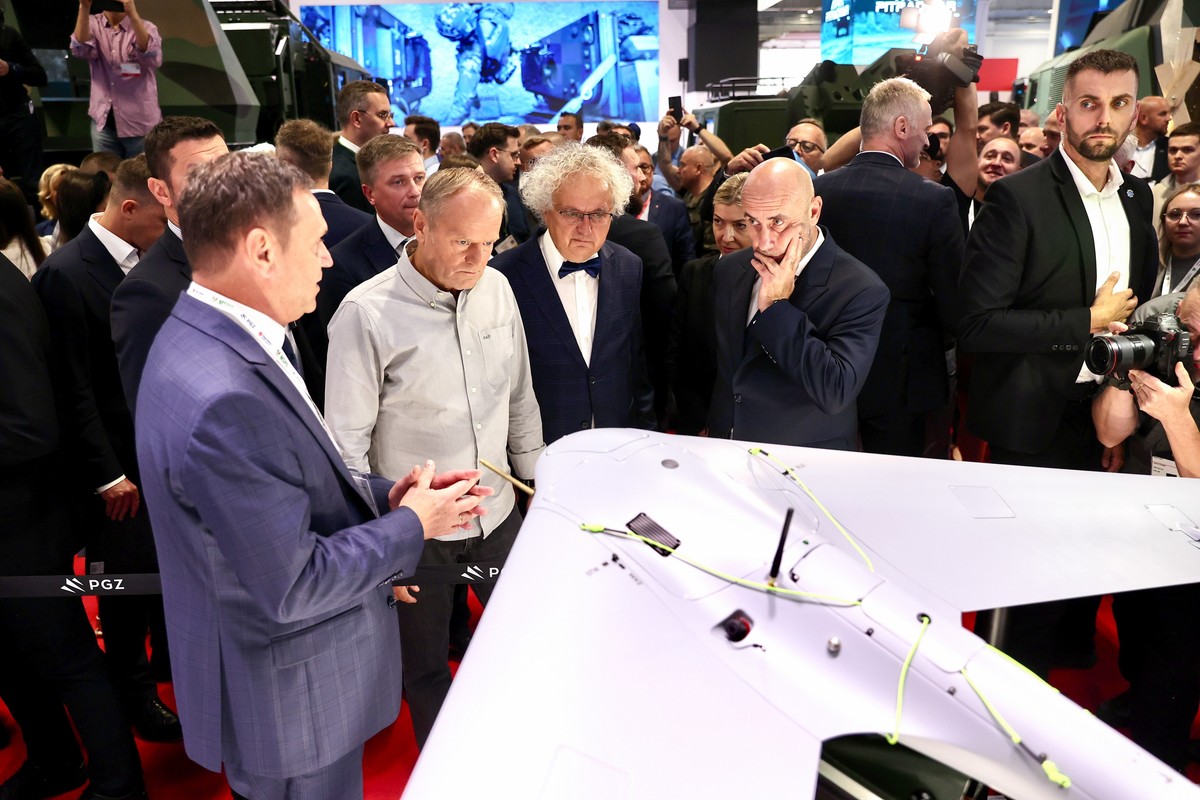 Mężczyźni w garniturach stojący przy dronie, który 3 września 2025 r. był prezentowany na Międzynarodowym Salonie Przemysłu Obronnego w Kielcach
