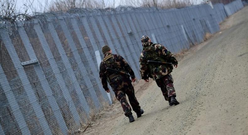 Soldiers patrol along the border fence on the Hungarian-Serbian border in February 2017