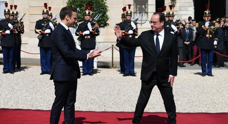 Hollande (right) leaving the Elysee Palace at the end of his formal handover to President Emmanuel Macron (left) on May 14 this year