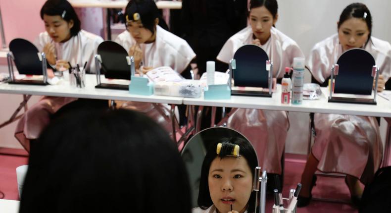 Japanese women applying makeup