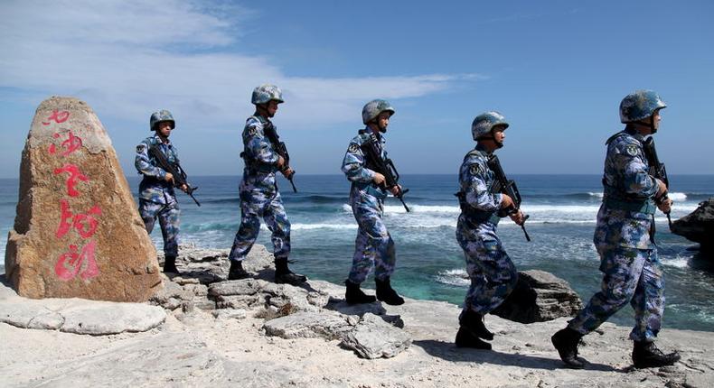 Soldiers of China's People's Liberation Army (PLA) Navy patrol at Woody Island, in the Paracel Archipelago, which is known in China as the Xisha Islands, January 29, 2016. REUTERS/Stringer