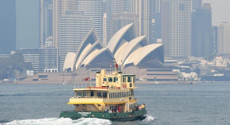 A ferry heads toward Sydney's Circular Quay as the city is shrouded in smoke