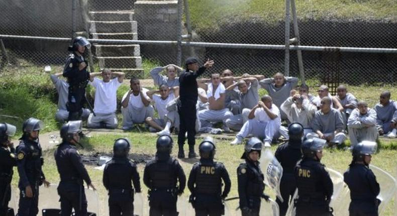 Riot police control inmates at a juvenile detention center in San Jose Pinula, east of Guatemala City, following a deadly prison riot