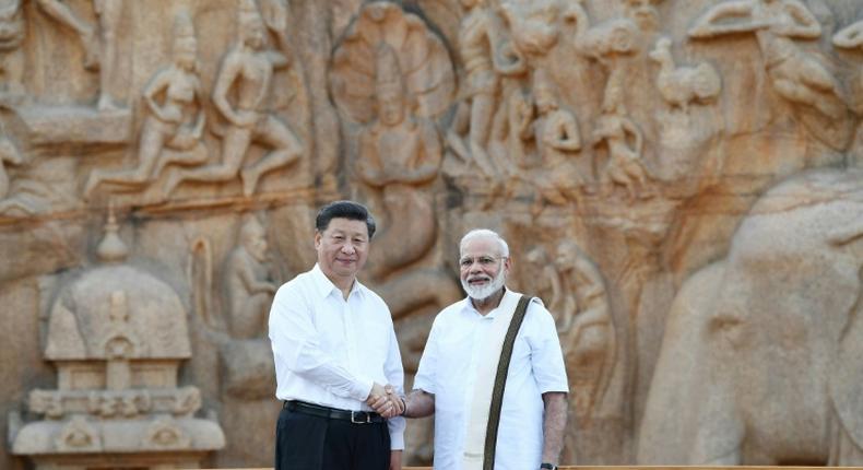 India's Prime Minister Narendra Modi (R) told Chinese President Xi Jinping their summit would launch a 'new era of cooperation' between the Asian giants