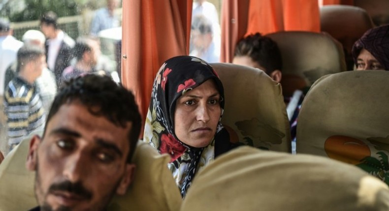 Syrian victims of a suspected chemical attack are carried in a bus back to the Syrian border after treatment in Turkey on April 7, 2017