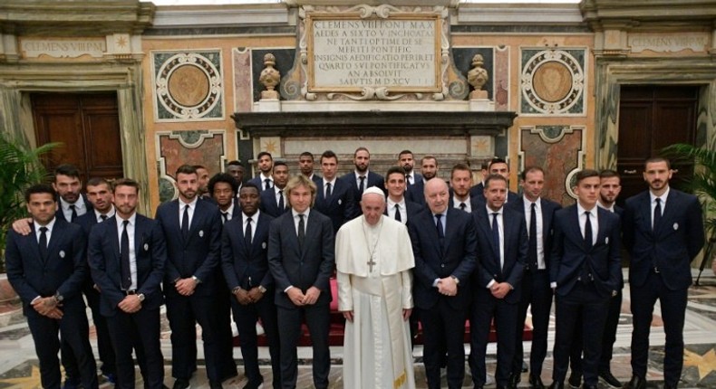 Pope Francis posing with members and players of the Juventus and Lazio teams at the end of an audience with Juventus and Lazio players on the eve of the Tim Cup final