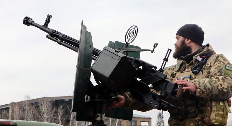 A serviceman stands behind a machine gun mounted on one of the 10 Ford F250 and F350 four-wheel drive pickup trucks to be conveyed from the HEROCAR Project to Ukraine's Armed Forces under the Guardians of the Sky programme in northern Ukraine on April 1, 2023.Volodymyr Tarasov/Ukrinform/Future Publishing via Getty Images