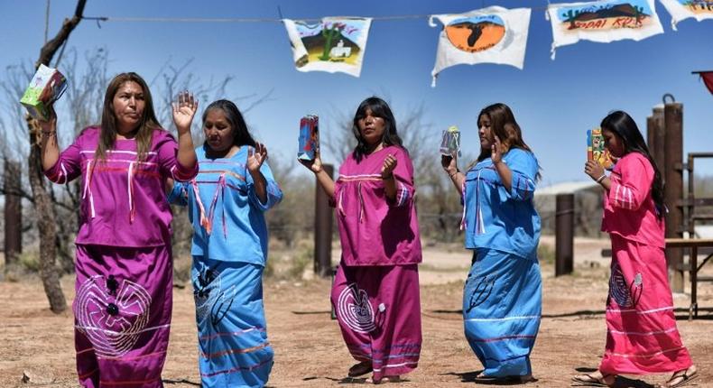 Indigenous people from the Tohono O'odham ethnic group dance and sing to protest against US President Donald Trump's intention to build a new wall in the border between Mexico and United States, in the Altar desert, northern Mexico