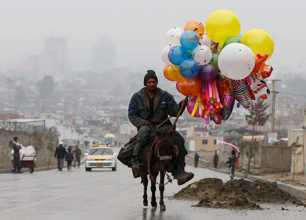 An Afghan man rides on his donkey during Newroz Day celebrations in Kabul