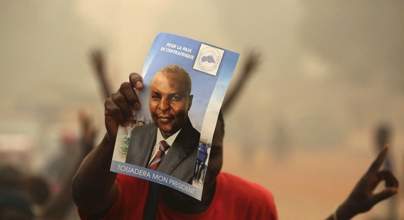 Supporters of presidential candidate Faustin-Archange Touadera holds a poster during a campaign in Bangui, Central African Republic, February 12, 2016. REUTERS/Siegfried Modola