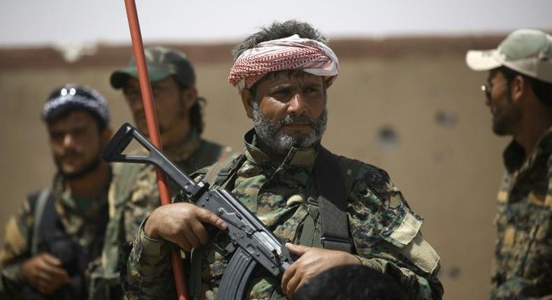 Members of the US-backed Syrian Democratic Forces (SDF) stand in the village of Hazima on the northern outskirts of the Islamic State (IS) group's Syrian bastion of Raqa on June 6, 2017