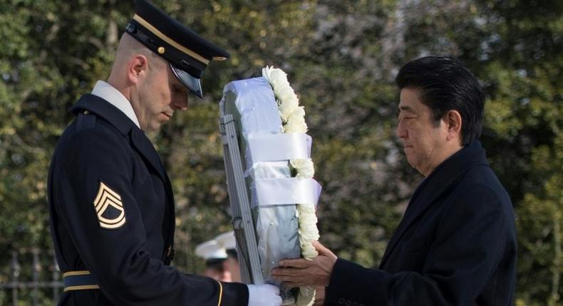 Japanese Prime Minister Shinzo Abe lays a wreath at the Tomb of the Unknown Soldier at Arlington National Cemetery, in Virginia, on February 10, 2017