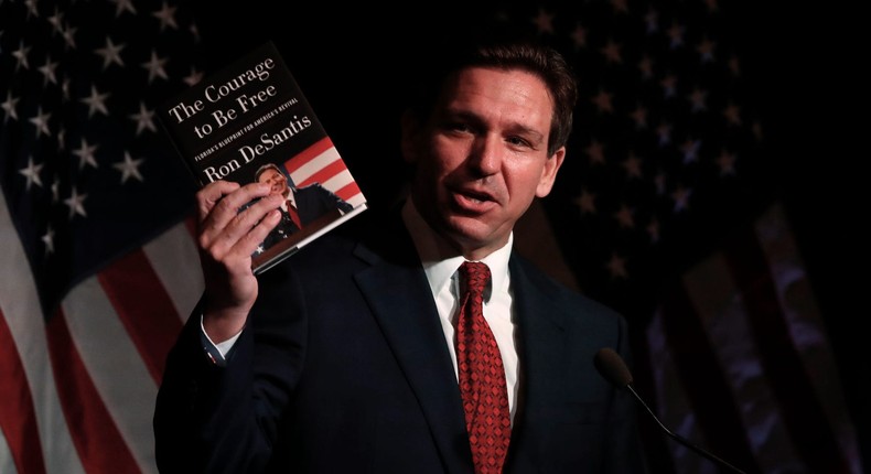 Florida Gov. Ron DeSantis holds his book while speaking at the Midland County Republican Party Dave Camp Spring Breakfast on April 6, 2023 in Midland, Michigan. While in Michigan, DeSantis will also visit Hillsdale College, a small, Christian liberal arts school.Chris duMond/Getty Images