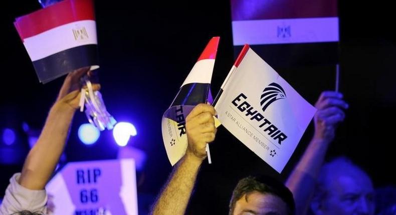 People hold EgyptAir flags during a candlelight vigil for the victims of EgyptAir flight 804, at the Cairo Opera House in Cairo, Egypt May 26, 2016. 