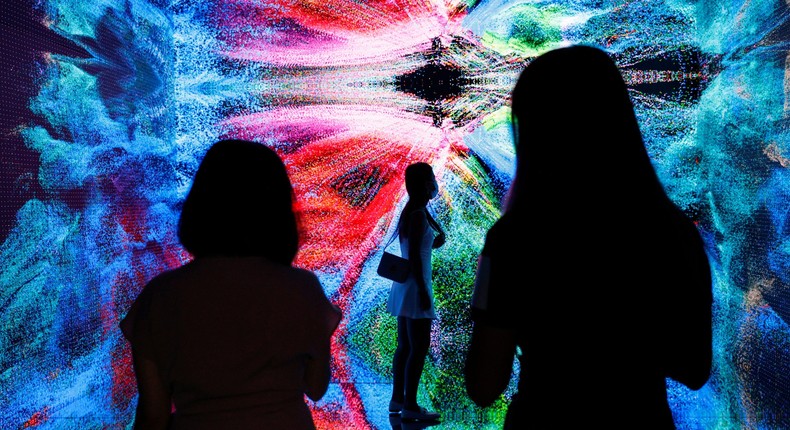 Viewers take in the art installation Machine Hallucinations - Space: Metaverse by Refik Anadol.