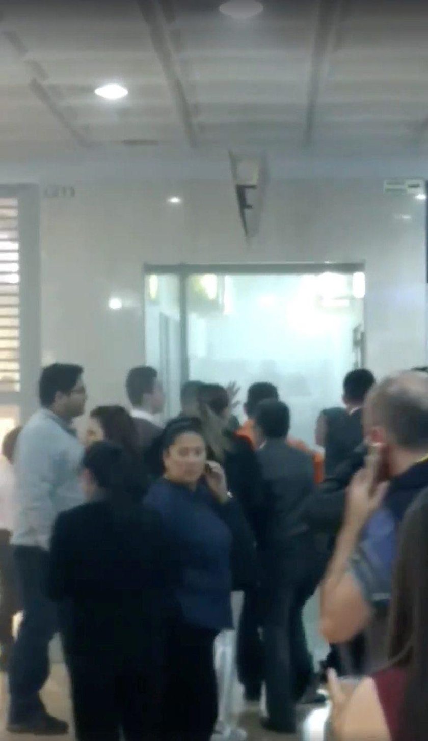 Police officers stand next to escalators inside the Andino shopping center after an explosive device