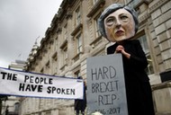 Protestor wearing a Theresa May mask is seen the day after Britain's election in London