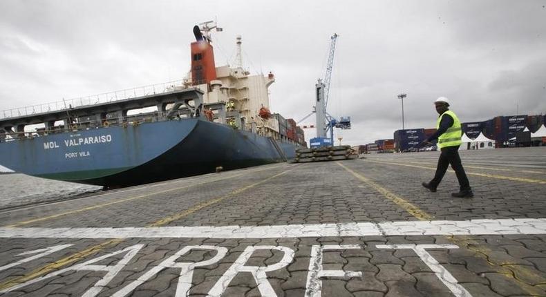 A man walks at a container port in Abidjan October 4, 2012. REUTERS/Thierry Gouegnon