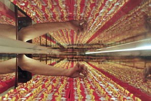 A shop attendant picks a gold ring for a customer at a store in Shenyang, China's Liaoning province