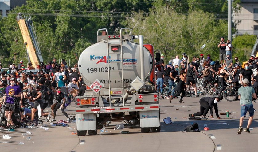 Protesters scale a truck that was driven into a rally