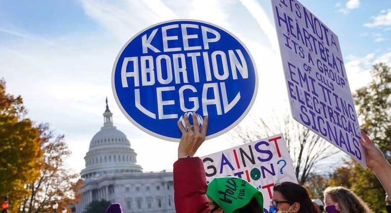 Participants hold signs during the Women's March at the US Supreme Court.