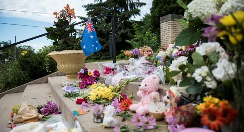 Flowers and signs memorialising Justine Damond are placed on the stairs of the Lake Harriet Spiritual Community centre in Minneapolis, Minnesota, on July 18, 2017