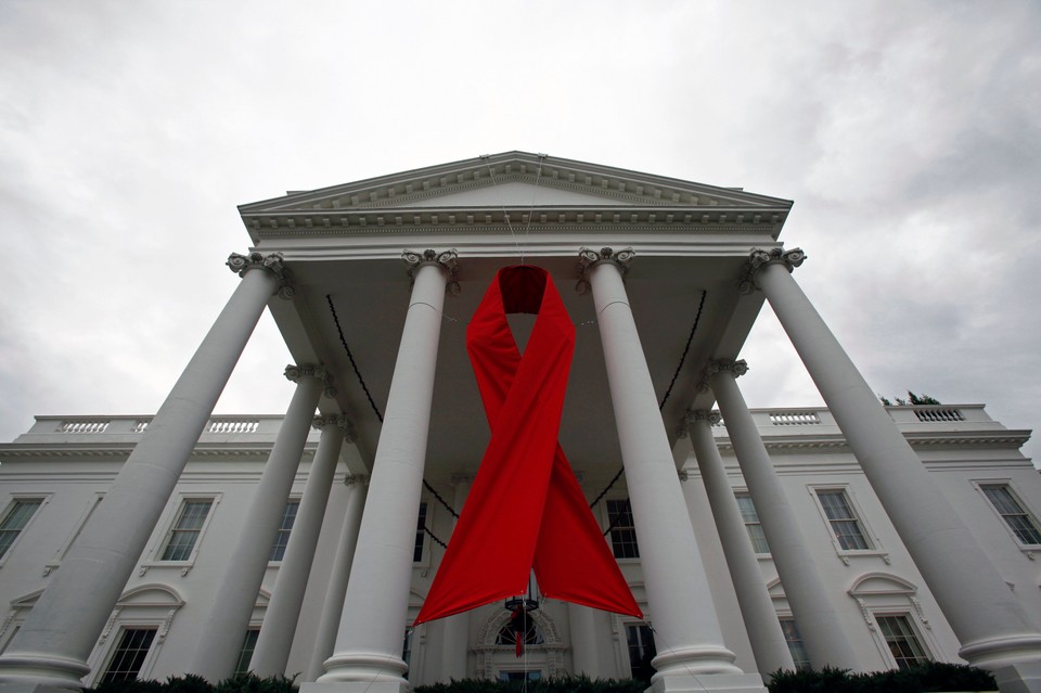 An AIDS ribbon hangs from the North Portico of the White House in Washington in recognition for tomorrow's World AIDS Day