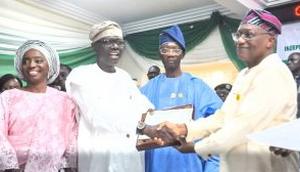 Gov. Babajide Sanwo-Olu (Second from Left) receiving Certificate of Return from INEC National Commissioner, Mr Sam Olumekun (Fourth from Left) on Thursday in Lagos.