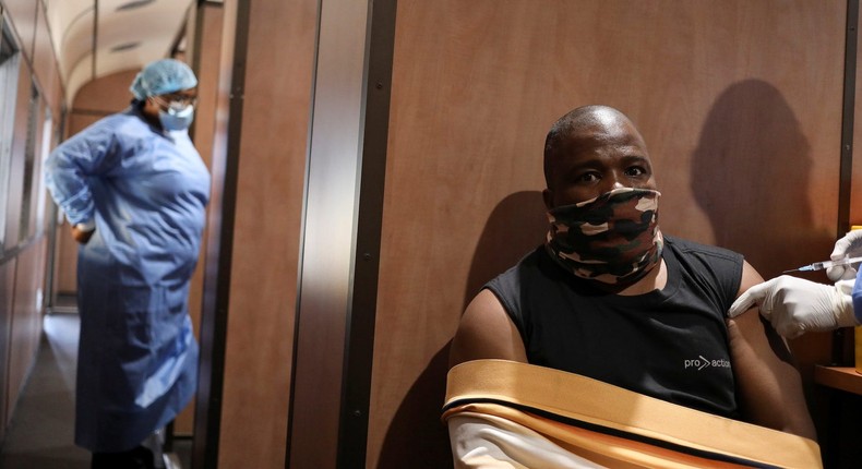 A man receiving a coronavirus vaccination on a train in South Africa.