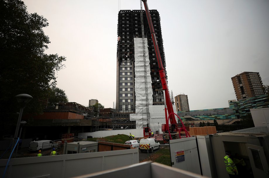 A crane helps erect scaffolding around Grenfell Tower in October.