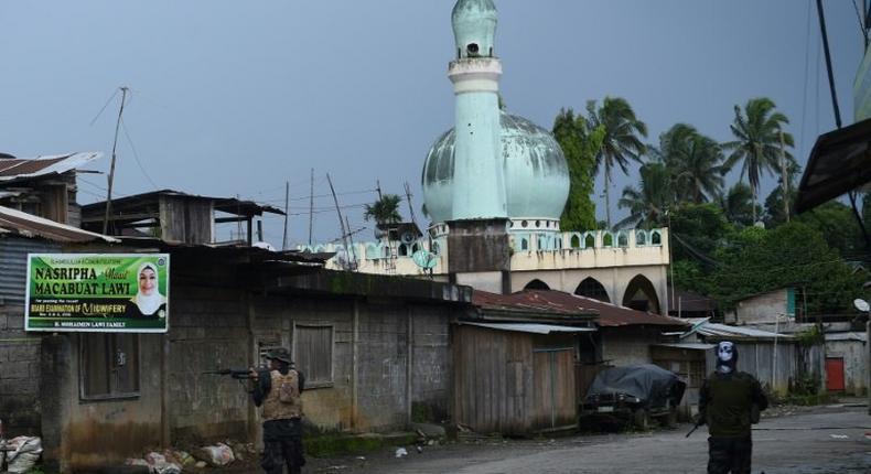 Government troops patrol a deserted street near the position of Islamic militants in Marawi, on the southern island of Mindanao on May 27, 2017