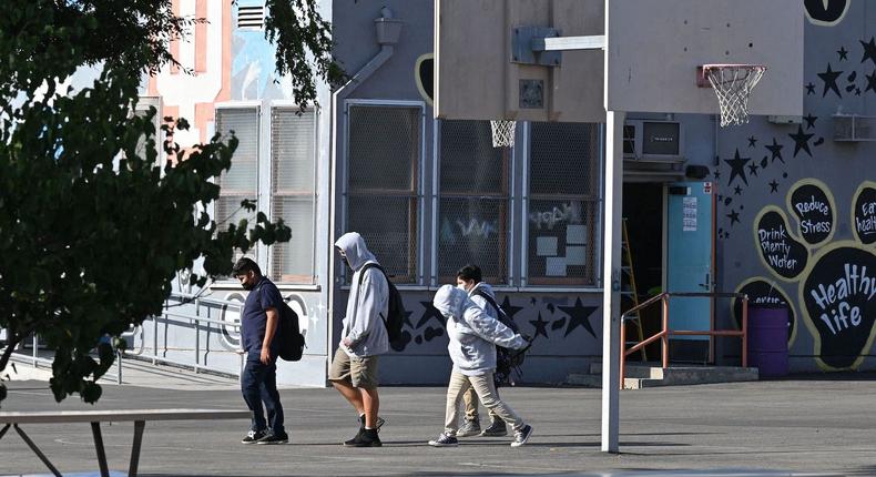 Students walk to their classrooms at a public middle school in Los Angeles, California, September 10, 2021.
