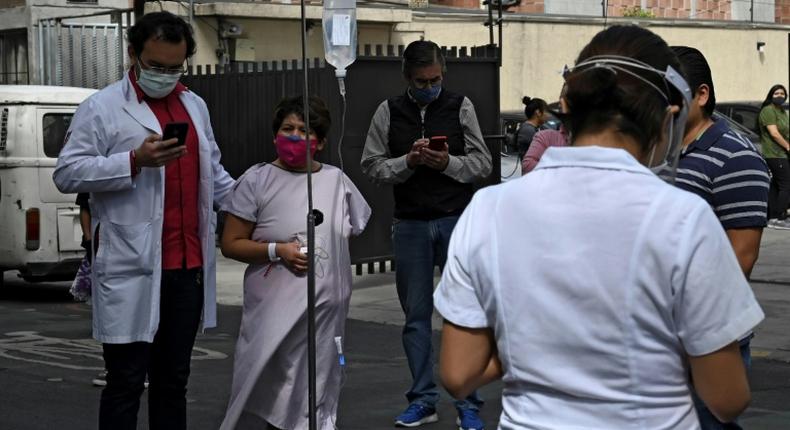 People gather outside a hospital in Mexico City, on June 23, 2020, after a powerful quake rocked the south of the county