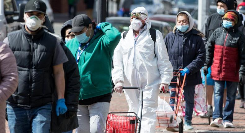 Residents line up to receive food distributed by the National Guard at Chelsea City Hall on April 17, 2020 in Chelsea, Massachusetts.