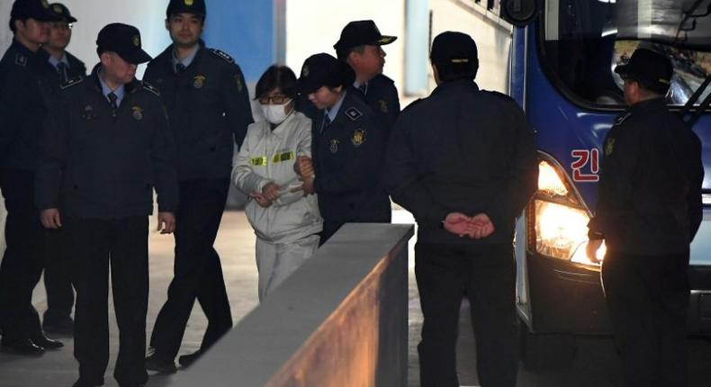 Choi Soon-Sil (C), at the centre of South Korea's corruption scandal, faces trial on charges of embezzlement and abuse of power