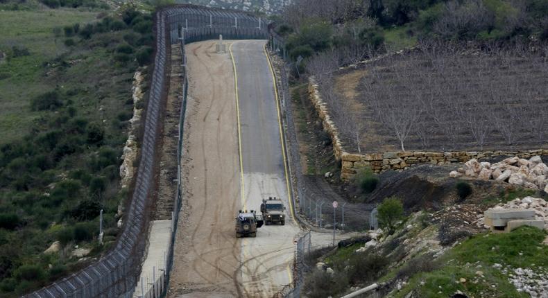 Israeli military vehicles patrol the border fence with Syria in the Israeli-annexed Golan Heights