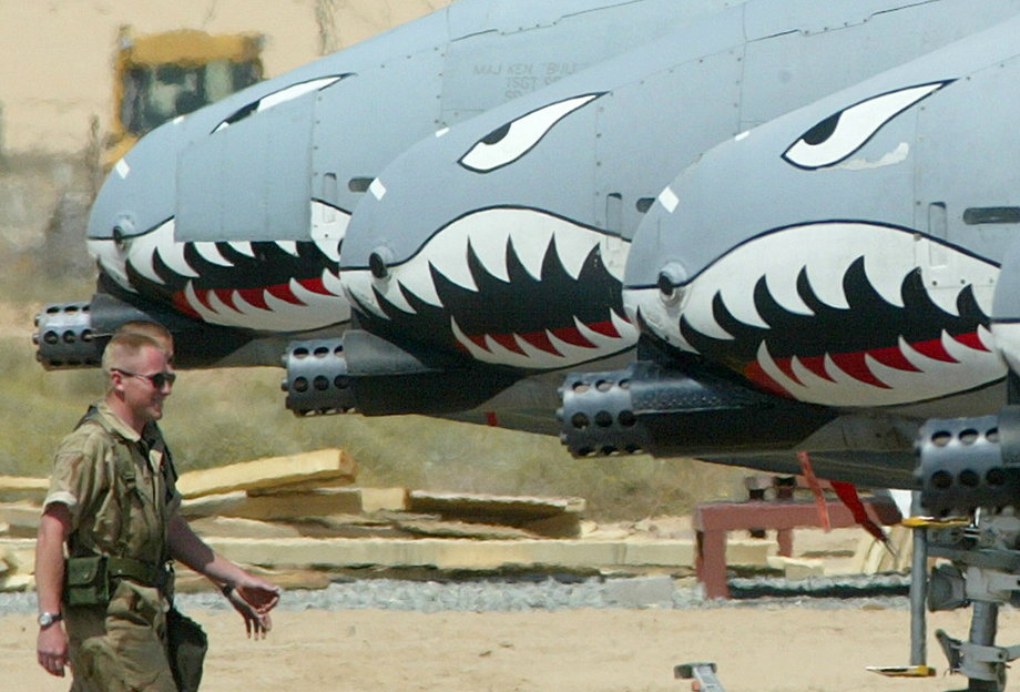 A US ground crew member walks past a line of American A-10s on an airbase in Kuwait on March 16, 2003.