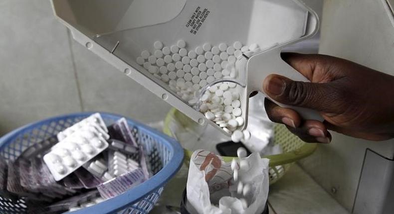 Ruth Munyao, a pharmacist, dispenses anti-retroviral (ARV) drugs at the Mater Hospital in Kenya's capital Nairobi, September 10, 2015. REUTERS/Thomas Mukoya