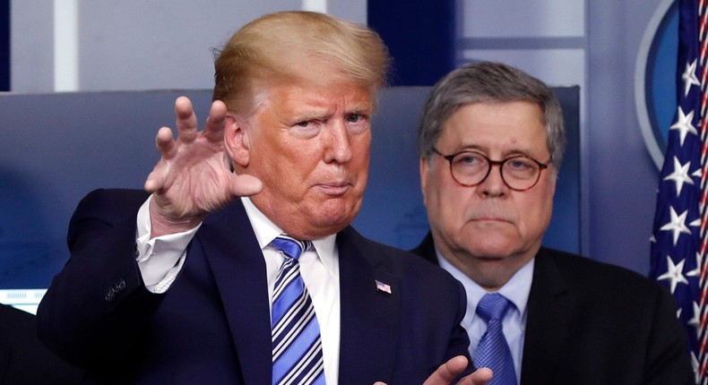 FILE- In this March 23, 2020 file photo, President Donald Trump talks during a briefing about the coronavirus in the James Brady Briefing Room, Monday, March 23, 2020, in Washington, as Attorney General William Barr looks on. Legislation to extend surveillance authorities that the FBI sees as vital in fighting terrorism was thrown in doubt Wednesday as President Donald Trump, the Justice Department and congressional Republicans all came out in opposition. (AP Photo/Alex Brandon)