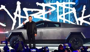 Tesla CEO Elon Musk stands in front of the Cybertruck during its unveiling on November 21, 2019.