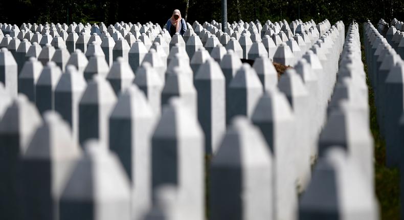 A woman between gravestones at the Memorial Center in Potocari near Srebrenica, Bosnia and Herzegovina, on Friday.