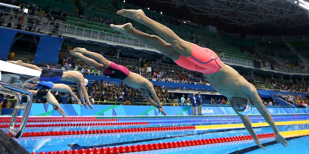 Swimmers jump off the starting blocks for the men's 200-meter freestyle final at the 2016 Rio Olympics.