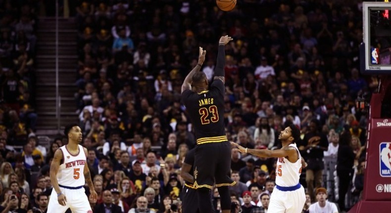 LeBron James #23 of the Cleveland Cavaliers shoots in the first quarter against Derrick Rose #25 of the New York Knicks on October 25, 2016 in Ohio