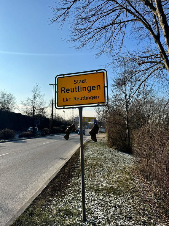 Buty zawieszone na znaku drogowym symbolem protestu rolników w Niemczech