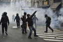 Protesters throw objects during a rally against Expo 2015 in Milan