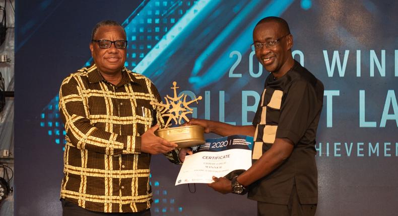 KPA Ag. Managing Director Amb. John Mwangemi (left) handing over certificate to winner of Lifetime Achievement Award Gilbert Langat at the EAMA 2020 Awards